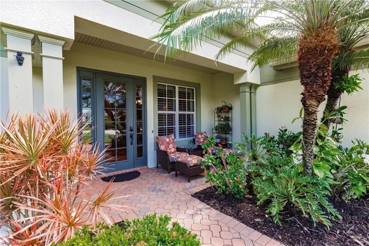 Doorway to property with stucco siding, french doors, and a patio