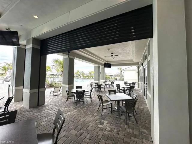 View of patio / terrace featuring outdoor dining space poolside at the Clubhouse