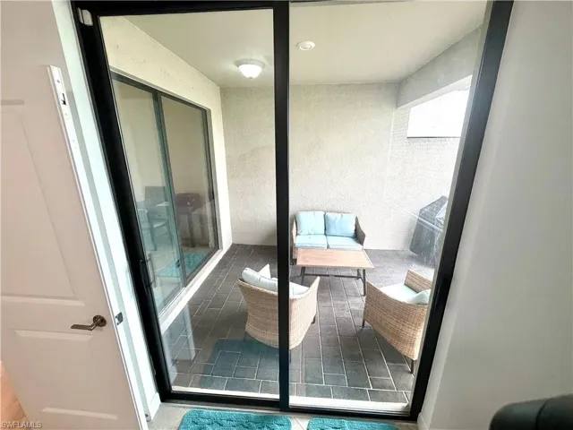 Lanai featuring outdoor lounge area, screened and access from bedroom