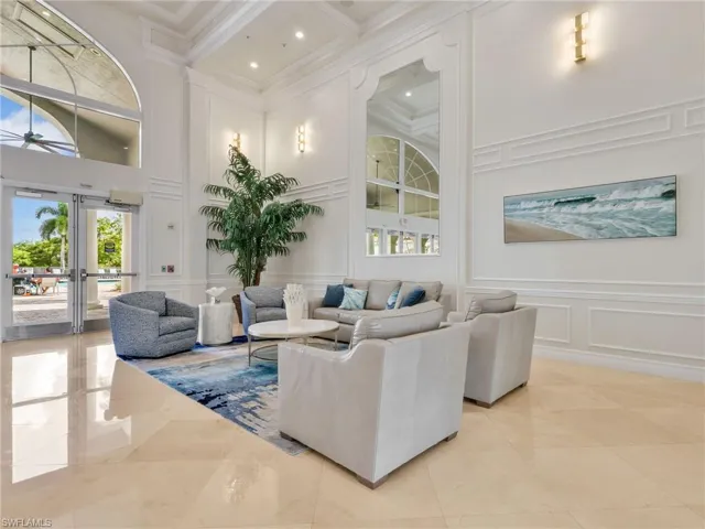 Soaring high ceilings with recessed lighting, decorative wall molding, polished tile flooring, and arched window