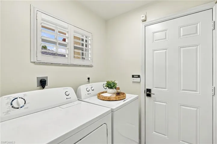 Window with white plantation shutters and trim