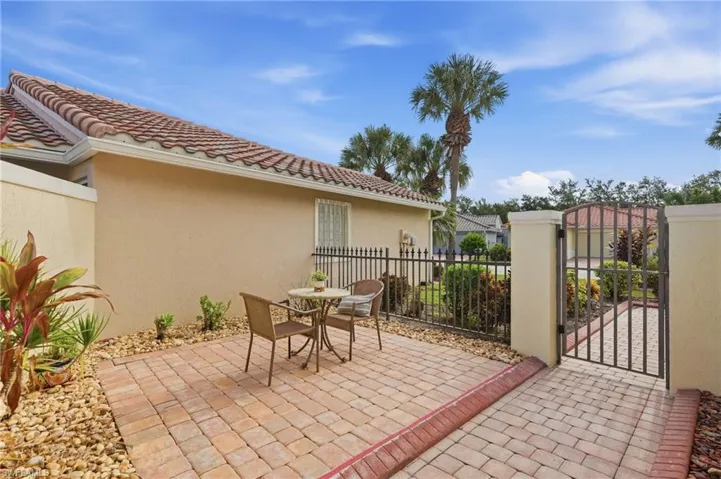 Paved patio area featuring brick-patterned pavers and a decorative stone border
