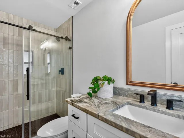 Primary bathroom with vanity and a stall shower