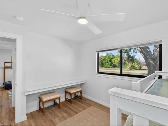 Bedroom featuring light wood-style floors and ceiling fan with desk for study and hobbies