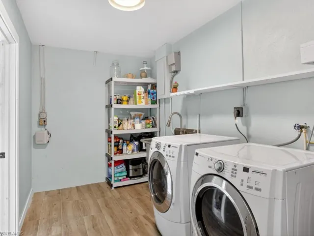 Laundry area featuring separate washer and dryer and leading to garage