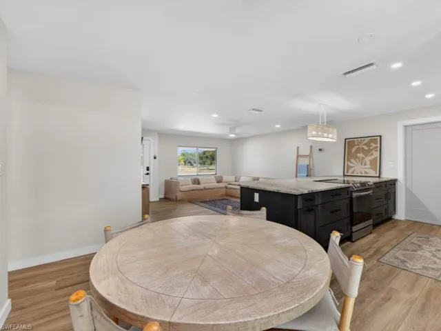 Dining area with recessed lighting and light wood finished floors