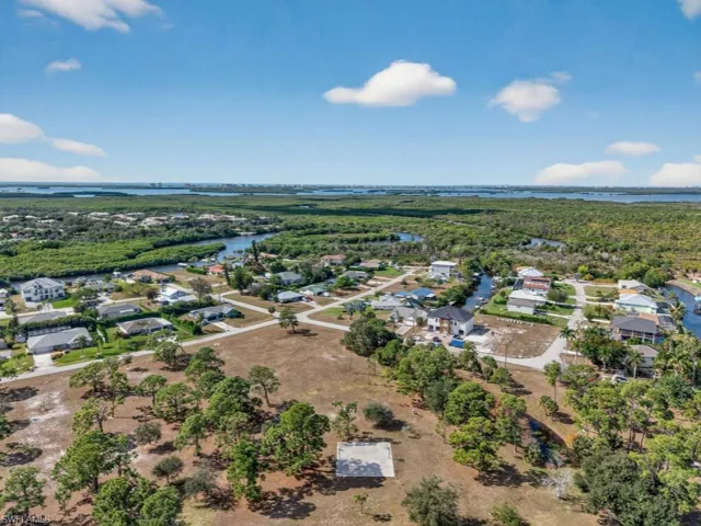 Aerial perspective of suburban area with a nearby body of water