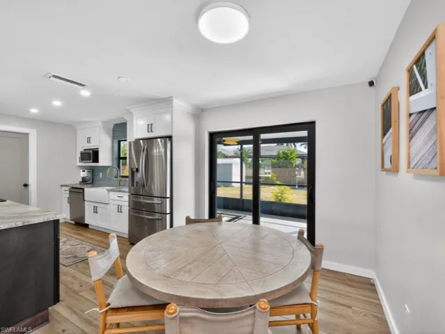 Dining space with light wood-style flooring and recessed lighting