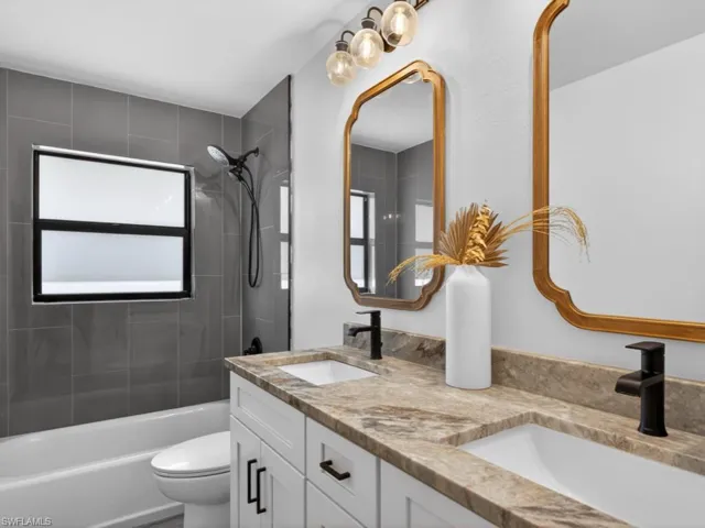 Full bathroom with  shower/tub combination and double vanity