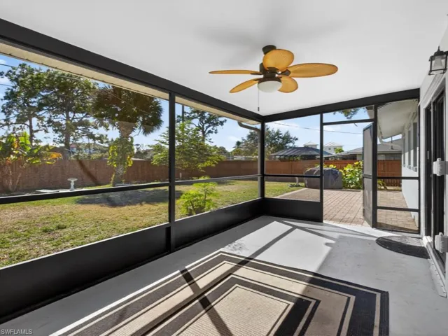Screened porch leading to fully fenced rear yard