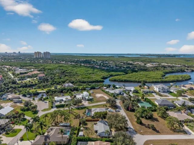 Aerial perspective of suburban area featuring a large body of water