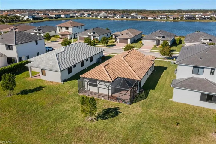 Birds eye view of property with a water view