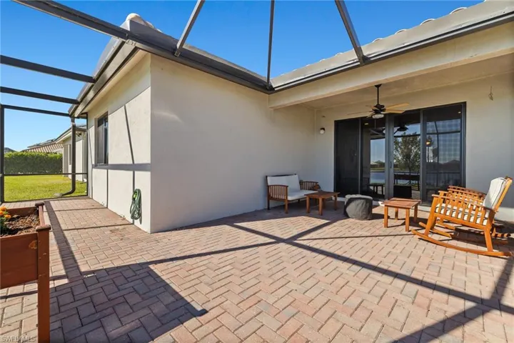 View of patio featuring ceiling fan and a lanai