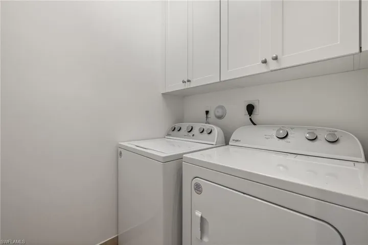 Laundry room with cabinets and washer and dryer