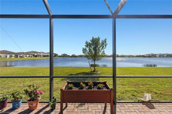 Sunroom / solarium with a water view and a wealth of natural light