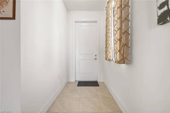 Doorway to outside with light tile patterned flooring