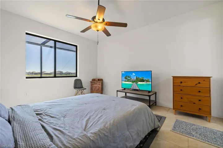 Tiled bedroom with ceiling fan