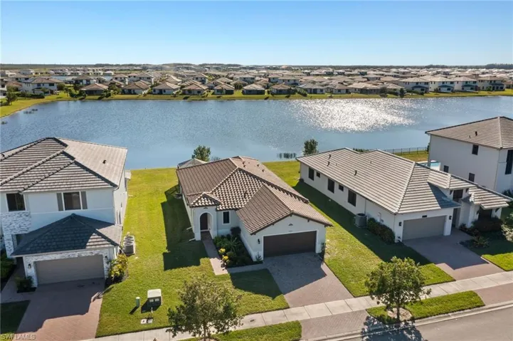 Birds eye view of property with a water view