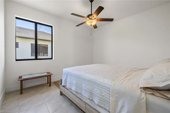 Tiled bedroom with ceiling fan