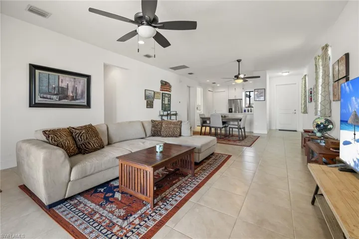 Tiled living room featuring ceiling fan