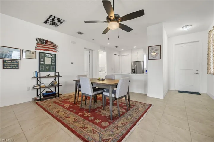 Tiled dining area featuring ceiling fan