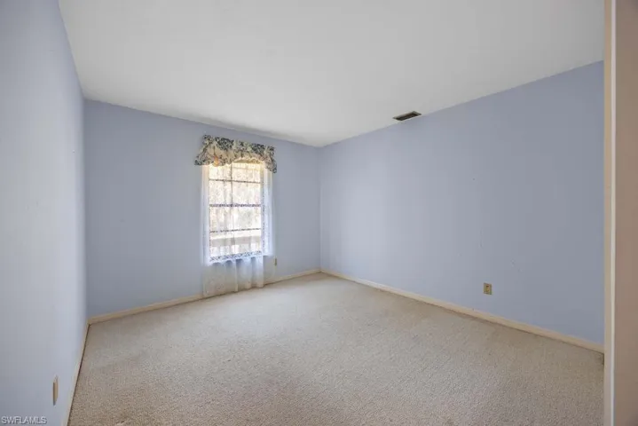 Spare room with light colored carpet