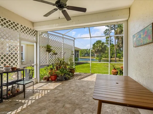 Screened patio with stone-finish flooring and a ceiling fan