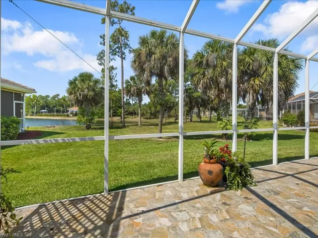 Screened outdoor living space featuring natural stone tile flooring