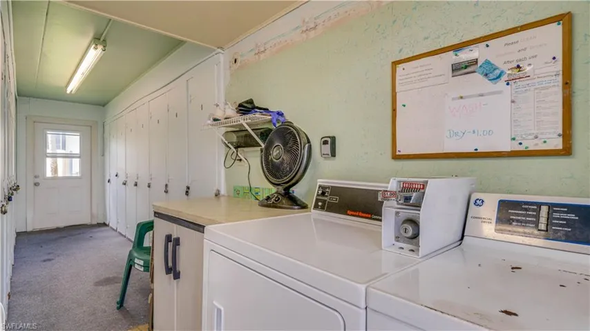 Laundry area with washing machine and dryer and storage locker
