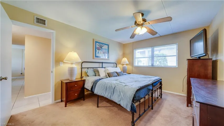 Carpeted bedroom featuring ceiling fan