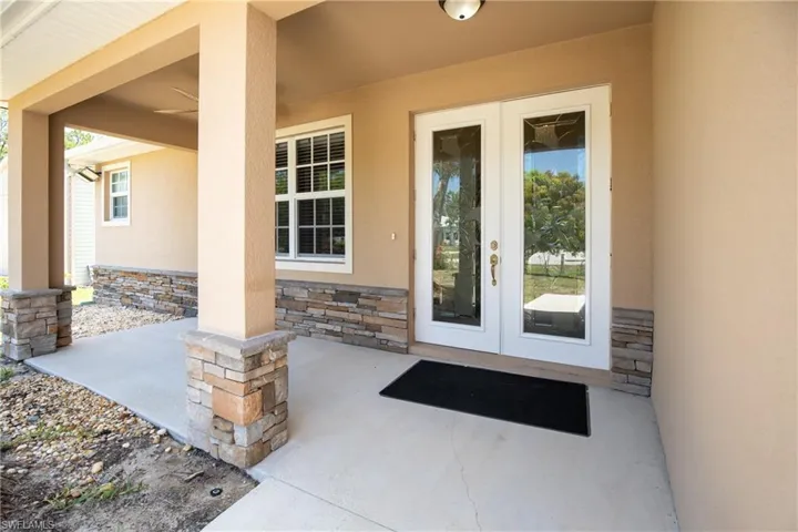 Doorway to property featuring a covered patio and french doors
