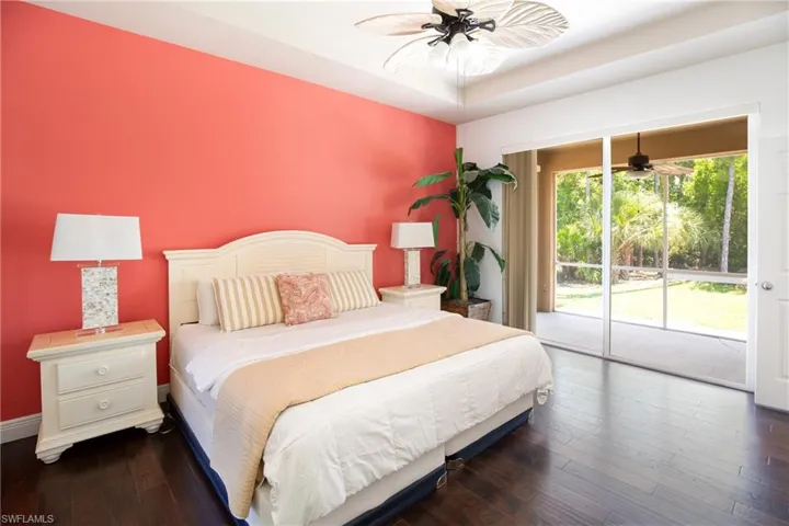 Primary Bedroom featuring dark hardwood / wood-style floors, ceiling fan, and access to outside