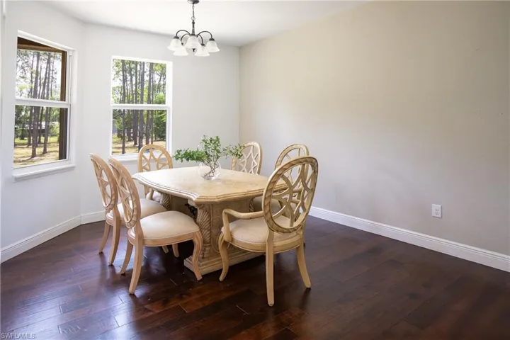 Dining room with a wealth of natural light, dark hardwood flooring