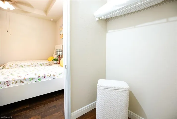 Bedroom featuring ceiling fan and dark hardwood / wood-style flooring
