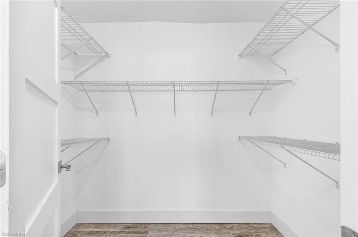 Spacious closet with light wood-type flooring