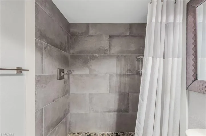 Full bath featuring a shower stall