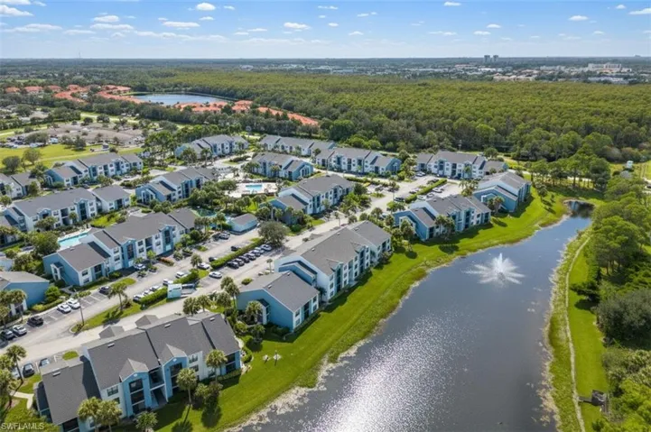 Drone / aerial view of a large body of water and a heavily wooded area