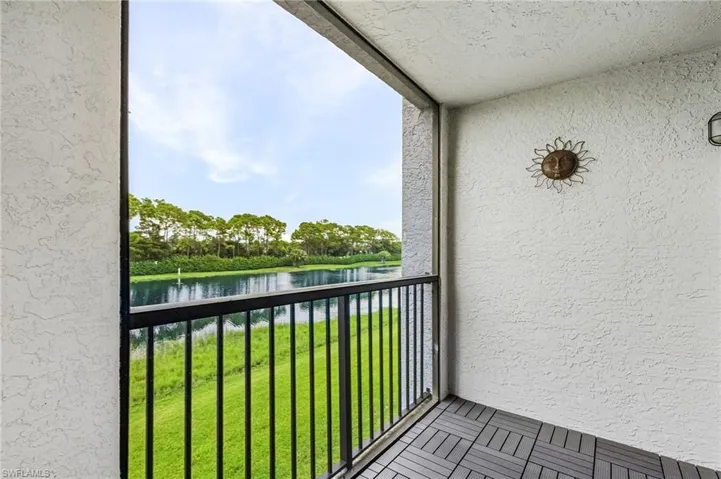Balcony featuring a water view and a sunroom