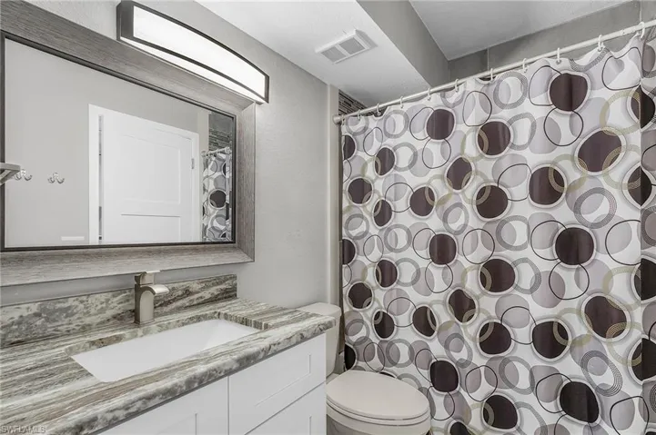 Bathroom with vanity and a shower with shower curtain
