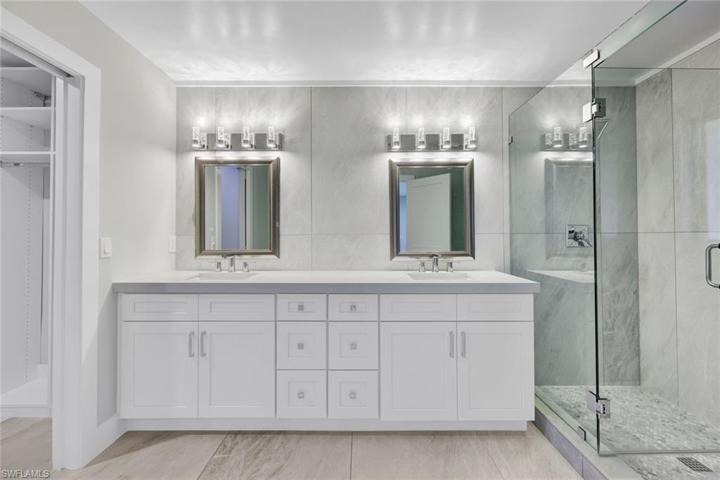 Luxurious en suite bath feels like an upscale spa - tiled walk-in shower & dual sinks. There is also a custom walk in closet located inside the primary suite bathroom....