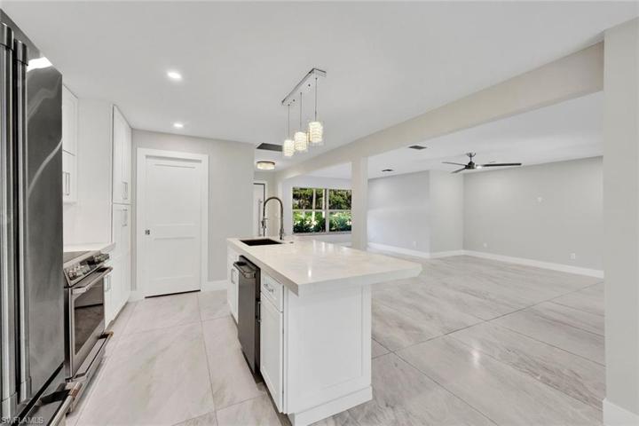 View of living area from kitchen island, complete with GORGEOUS quartz countertops.