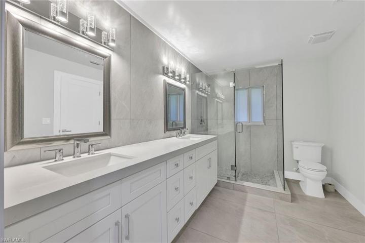 Gorgeous primary bathroom with walk-in shower and dual vanities.