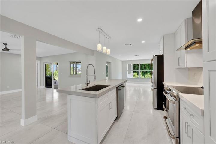 Kitchen open to living and dining areas. Notice how LIGHT and BRIGHT this home is!