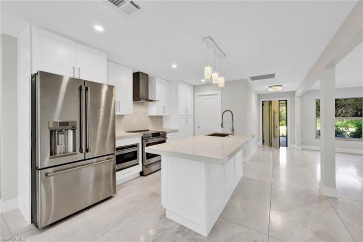 Cafe stainless steel appliances, large island, & premium kitchen cabinets/countertops are just a few of the kitchen's highlights.