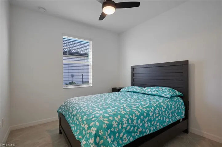 Bedroom featuring a ceiling fan and light tile patterned floors