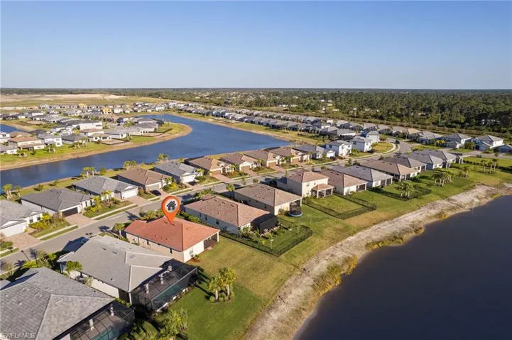 Aerial view of residential area featuring a nearby body of water