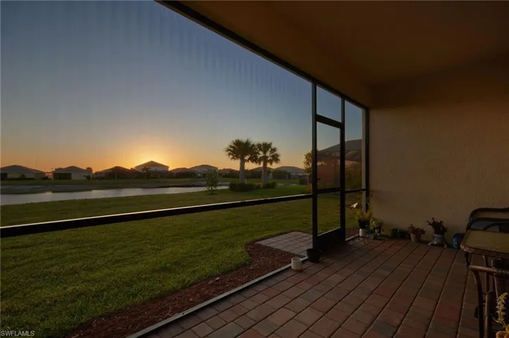 Unfurnished sunroom with a residential view and a water view