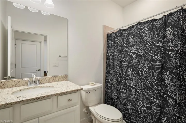 Bathroom with vanity and a shower with curtain