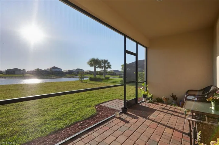 Unfurnished sunroom featuring a water view and a residential view