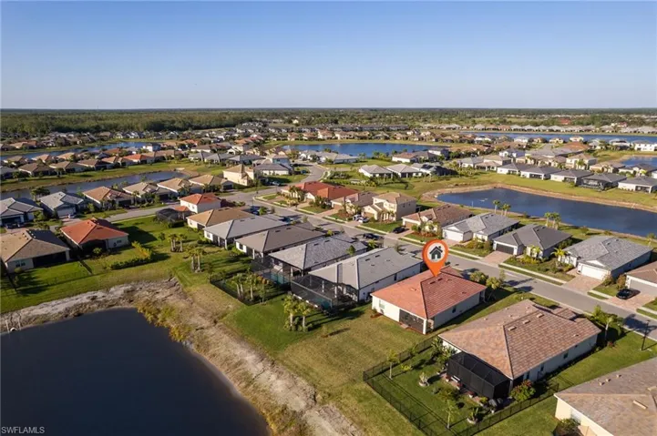 Aerial overview of property's location with a nearby body of water and nearby suburban area